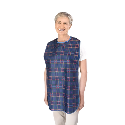Lady donning the long patient apron bib in the colour Blue Stuart.
