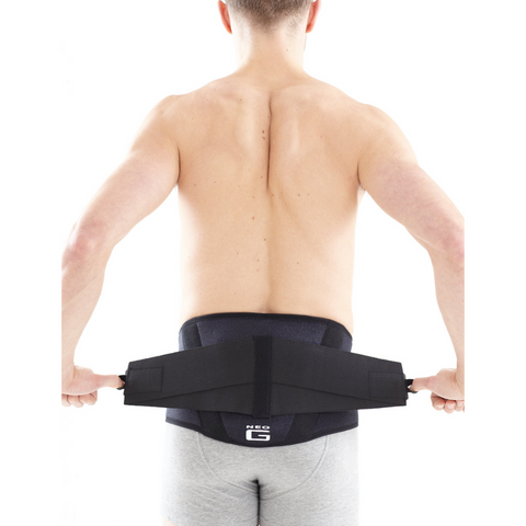 Neo G brace being adjusted by a user, demonstrating how the power straps provide variable compression.