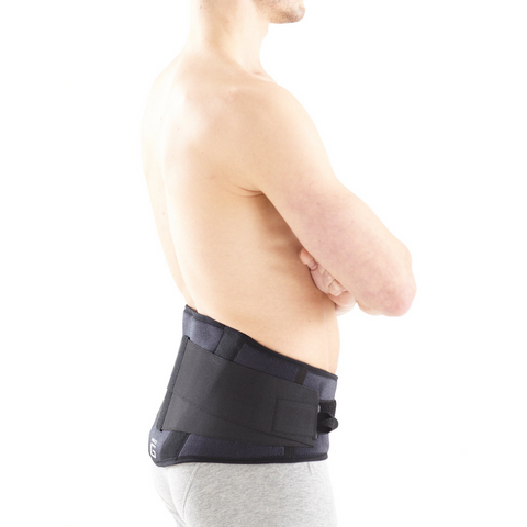 Lifestyle shot of someone using the brace while sitting at a desk, emphasizing daily use and postural support.