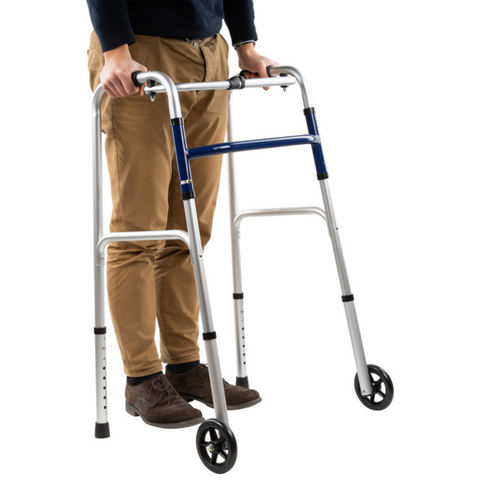 Compact indoor walking frame with 13 cm front wheels and PVC grip handles.