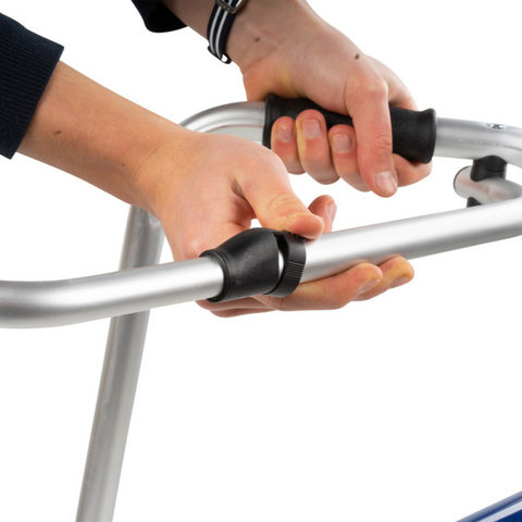 Close up of the Foldable aluminium walking aid for elderly users, showing how the mechanism works to fold the walker in the middle and supports up to 135 kg.