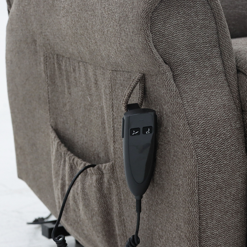 A close-up view of the side pocket on the Madison Two recliner in brown, designed to hold the handset securely for easy access during use.