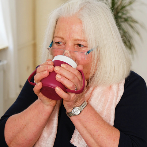 Ergonomic two-handled mug with a unique cone-shaped inner design, perfect for those with limited mobility. Keeps drinks warm for longer and is made from durable, BPA-free plastic.