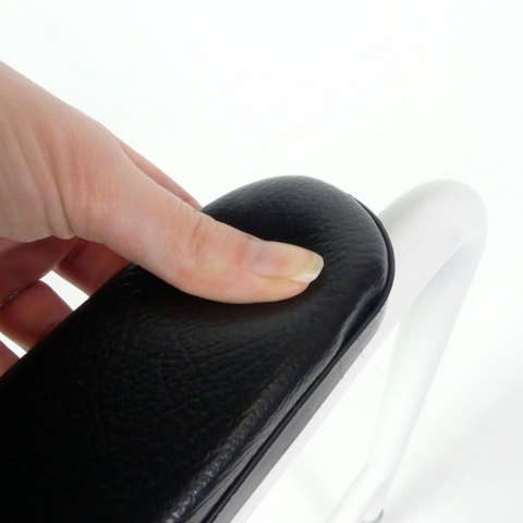 Close-up of moulded armrests on height adjustable toilet frame. Toilet frame with non-slip, non-marking rubber feet and adjustable height.