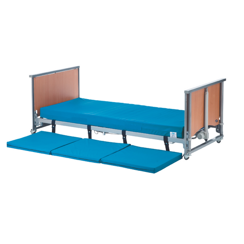 Caregiver adjusting the height of a Medley Ergo Low bed.