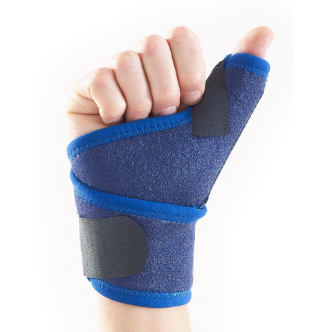 Person typing at keyboard while wearing thumb support brace for carpal tunnel relief.