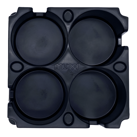 A top-down view of the Muggi Cup Holder showing the four cup wells, thumb grips, and the overall layout of the holder for easy and secure transportation.